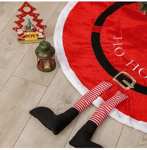 Detail of red plush Santa Christmas tree skirt with HO HO HO embroidery and leg accents