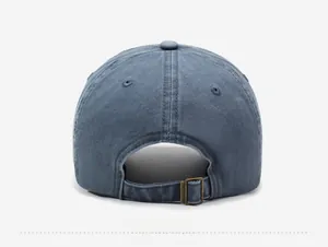 Detail view of washed gray-blue baseball cap featuring adjustable bronze metal buckle and strap