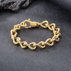 Detailed close-up of chunky gold-colored twisted rope chain bracelet with ornate lobster clasp