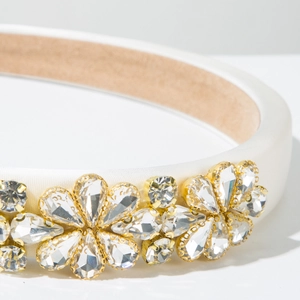 Nahaufnahme weißer Schwamm-Haarreif mit goldenen Strassblumen und Samtfutter