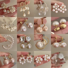 Detailed grid display of sixteen pairs of pearl and gold earrings in various styles