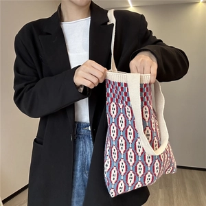 Close-up of knit tote bag with vintage red, white and blue geometric diamond patterns