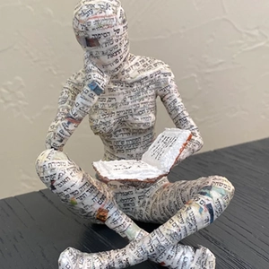 Abstract reading woman sculpture handcrafted from recycled newspaper for shelf decor
