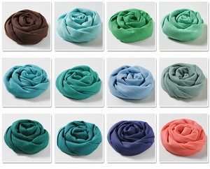 Detailed grid view of assorted cotton linen scarves folded into elegant rose shapes