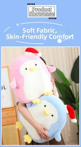 Close-up of person holding festive pink and blue plush penguin toys in home setting