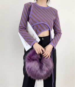 Detail shot of a purple faux fur fuzzy handbag styled with a Y2K punk aesthetic outfit