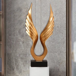 Modern gold angel wings sculpture on black base for elegant home and office decor