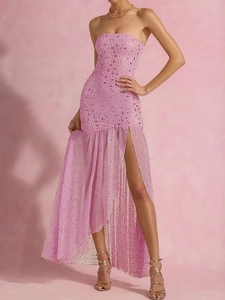 Close-up of pink strapless evening gown featuring sequins and ruffle split hem