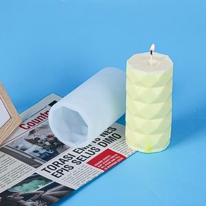 Detail of white silicone candle mold showing geometric diamond textured finish on wax