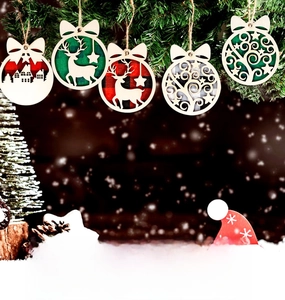 Detail of wooden Christmas ornaments with plaid backing and bows on pine branches