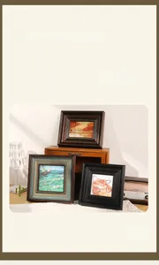 Close-up of vintage French picture frames in dark brown, blue-gold, and black wood finishes