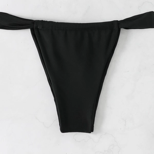 Detailed flat lay of black bikini bottoms featuring minimalist side strap design