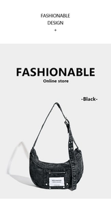 Detail of black washed denim hobo bag featuring wide strap with metal eyelets and mini pocket
