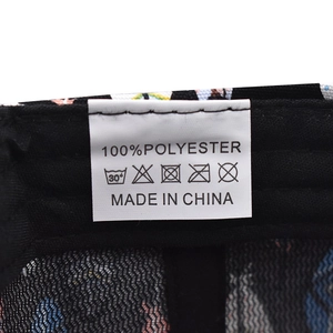 Detail view of the wash label inside the mesh baseball cap showing 100% polyester fabric