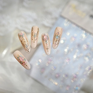 Matte pink almond nail stickers with gold bohemian totem patterns and colorful gems