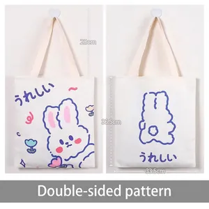 White canvas tote bag with blue cartoon rabbit design and 23cm handle for students
