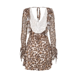 Detail view of leopard print mini dress featuring ruffle trim and sexy backless design
