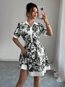 Detailed view of the black and white floral pattern and waist tie on the short sleeve dress
