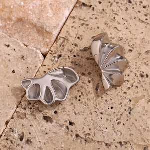 Macro shot of silver geometric flower petal earrings with a polished metallic finish