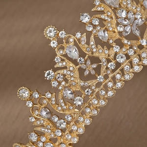 Macro shot of gold alloy bridal crown featuring luxury rhinestones and leaf motifs