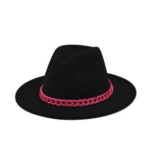 Detail of a black wide brim felt fedora hat featuring a chunky vibrant pink chain band