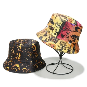 Halloween bucket hats with pumpkin, bat, and witch motifs on a minimal white backdrop