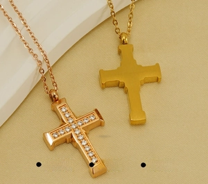 Close-up of 18K gold and rose gold stainless steel cross pendants with zircon stones