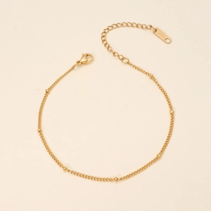 Detail of 18K gold plated stainless steel chain with gold beads and lobster clasp
