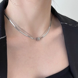Double-layered silver titanium steel necklace with sparkling crystal ring pendant on model