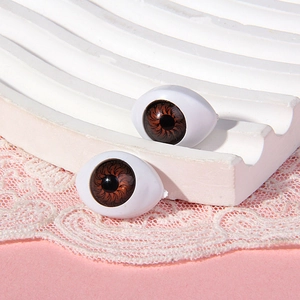 Macro view of 14x19mm brown acrylic boat-shaped eyes for dolls and craft projects