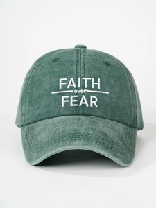 Detail of FAITH over FEAR white embroidery on vintage washed green cotton baseball cap