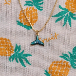 Elegant gold plated fishtail necklace with teal gradient enamel and glitter accents
