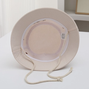 Beige cotton kids bucket hat with embroidered smiley face and windproof chin strap