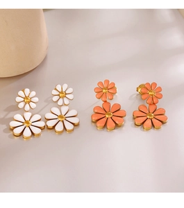 Detail of double daisy dangle earrings in white and orange pink with gold-plated edges