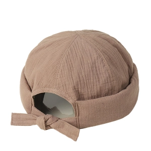 Brown cotton docker cap with textured fabric and stylish back tie knot detail