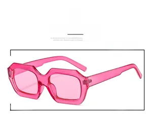 Close-up of retro Y2K rectangular sunglasses with translucent pink resin frames