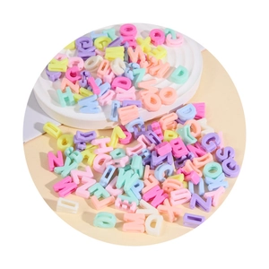 Detailed top view of various pastel macaron acrylic letter beads for DIY craft jewelry making