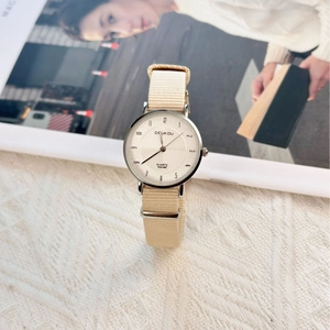 Minimalist women's quartz watch with beige nylon strap and silver sunray texture dial