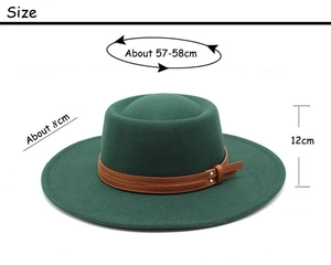 Detail of dark green flat top wool hat with brown leather belt and metal buckles