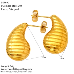 Detail of 18k gold plated stainless steel teardrop earrings with hammered texture finish