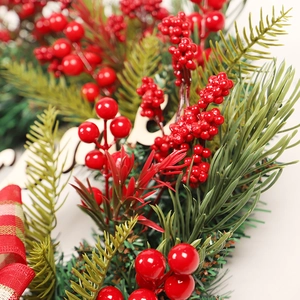 Christmas wreath with red berries, pine needles and Merry wooden sign for front door