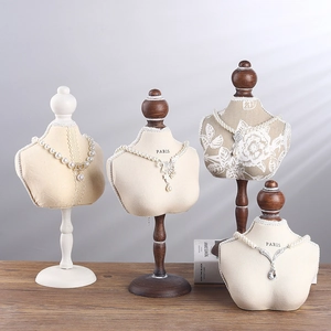 Minimalist portrait bust necklace display stands in assorted fabric finishes and wooden bases