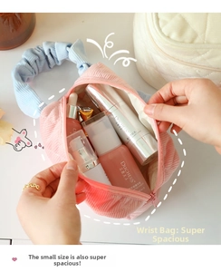 Detail of pink corduroy makeup bag showing large capacity for cosmetic bottles