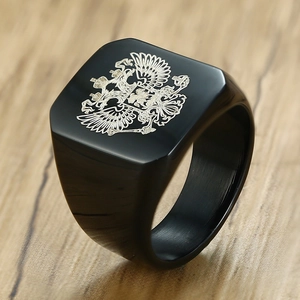 Macro side view of a matte black square men's ring with a silver double-headed eagle emblem