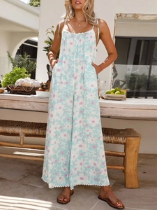 Outdoor shot of light blue floral jumpsuit with wide-leg design and spaghetti straps
