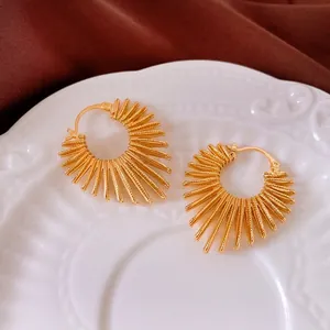 Golden sunburst hoop earrings with textured spikes and secure snap closure for women