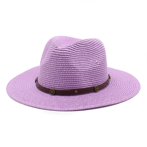 Detail of lavender straw fedora hat featuring a brown leather band and metallic studs