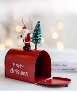 Detail of red metal Christmas mailbox ornament with Santa figure and miniature tree