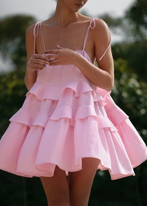 Detailed view of adjustable tie straps and tiered ruffled pink linen summer dress