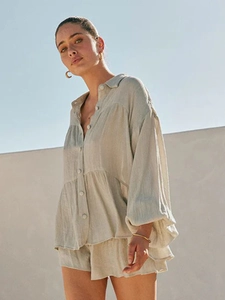 Detailed texture of beige linen lantern sleeve shirt and matching drawstring shorts